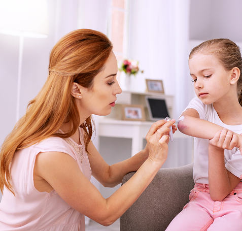 Femme en train de soigner la plaie d'une enfant
